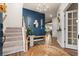 Stylish entryway with blue accent wall, wooden bench, and elegant staircase at 206 Red Bluff St, Summerville, SC 29483