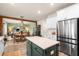 Bright kitchen features white cabinets, an island, and overlooks the dining and living spaces at 206 Red Bluff St, Summerville, SC 29483