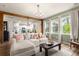 Bright living room that opens to kitchen, features a chandelier, and large windows at 206 Red Bluff St, Summerville, SC 29483