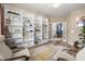 Bright living room with built-in bookshelves, stylish decor, and cozy seating, illuminated by a modern chandelier at 206 Red Bluff St, Summerville, SC 29483