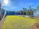 Community pool area with palm trees, lounge chairs, and lush green lawn at 206 Red Bluff St, Summerville, SC 29483