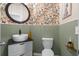 Stylish powder room featuring floral wallpaper, a vessel sink, and beadboard paneling creating a charming space at 206 Red Bluff St, Summerville, SC 29483
