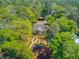 Lush tree coverage surrounds the home, with beautiful gardens, landscaped grounds, and more at 207 Central Ave, Summerville, SC 29483