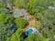 Aerial view of home with large pool, lush lawns and mature trees creating a private oasis at 207 Central Ave, Summerville, SC 29483