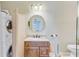Bathroom with granite vanity, decorative mirror, and convenient stacked washer and dryer at 207 Central Ave, Summerville, SC 29483