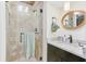Modern bathroom with a glass-enclosed shower, granite countertop, and elegant fixtures in a contemporary design at 207 Central Ave, Summerville, SC 29483