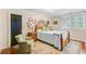 Cozy bedroom with hardwood floors, classic furnishings, and natural light from the shuttered windows at 207 Central Ave, Summerville, SC 29483