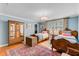 Charming bedroom with two beds, hardwood floors, and a vintage wardrobe, creating a cozy atmosphere at 207 Central Ave, Summerville, SC 29483