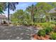 Long gravel driveway lined with brick pavers and lush landscaping leading to a beautiful home at 207 Central Ave, Summerville, SC 29483