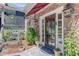 Charming home entrance featuring brick accents, an awning, and decorative landscaping at 207 Central Ave, Summerville, SC 29483