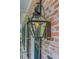 Close-up of a decorative gas lantern mounted on a classic brick exterior at 207 Central Ave, Summerville, SC 29483