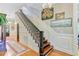 Elegant foyer with detailed staircase, hardwood floors, and decorative wall art, creating a welcoming entrance at 207 Central Ave, Summerville, SC 29483