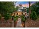 Charming brick home with manicured landscaping and inviting entrance at sunset at 207 Central Ave, Summerville, SC 29483