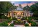 Inviting brick home boasts manicured landscaping and a decorative fountain feature at 207 Central Ave, Summerville, SC 29483
