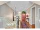 Upstairs hallway with hardwood floors, chandelier lighting, and decorative accents leading to various rooms at 207 Central Ave, Summerville, SC 29483