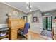 Traditional home office featuring a wooden roll-top desk, hardwood floors, and elegant lighting at 207 Central Ave, Summerville, SC 29483