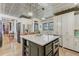 Open kitchen with island, quartz countertop, stainless steel appliances and access to other rooms at 207 Central Ave, Summerville, SC 29483
