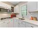 Bright kitchen featuring white cabinets, subway tile backsplash, and stainless steel appliances at 207 Central Ave, Summerville, SC 29483