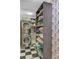 Efficient laundry room featuring a stacked washer and dryer, sleek black and white flooring, and built-in shelving for storage at 207 Central Ave, Summerville, SC 29483