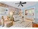 Comfortable living room with exposed brick wall, built-in shelving, and cozy seating arrangement at 207 Central Ave, Summerville, SC 29483