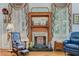 Cozy living room featuring a charming fireplace, rocking chair and plantation shutters at 207 Central Ave, Summerville, SC 29483