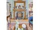 Charming living room features a carved wood fireplace and patterned chairs at 207 Central Ave, Summerville, SC 29483