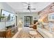 Bright living room with brick wall, media cabinet, and open access to the outdoor patio at 207 Central Ave, Summerville, SC 29483