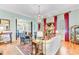 Bright living room features hardwood floors, a chandelier, and red curtains at 207 Central Ave, Summerville, SC 29483