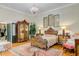 Spacious bedroom boasts a stunning chandelier, hardwood floors, and elegant decor at 207 Central Ave, Summerville, SC 29483