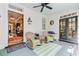 Inviting patio with wicker rocking chairs, ceiling fan, and view of the home's interior at 207 Central Ave, Summerville, SC 29483