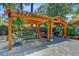 Spacious outdoor living with a wooden pergola, comfortable seating, and lush landscaping at 207 Central Ave, Summerville, SC 29483