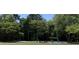Community playground shaded by trees, equipped with swings and climbing structures at 207 Central Ave, Summerville, SC 29483