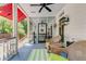 Relaxing screened-in porch with ceiling fan and comfortable wicker seating at 207 Central Ave, Summerville, SC 29483