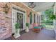 Welcoming front porch with rocking chairs, decorative wreath, and traditional design elements at 207 Central Ave, Summerville, SC 29483