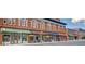 Charming storefronts along the street feature brick facades and colorful awnings creating an inviting atmosphere at 207 Central Ave, Summerville, SC 29483