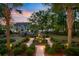 Expansive backyard featuring manicured landscaping, fountain and view of building at 207 Central Ave, Summerville, SC 29483