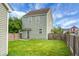 View of the fenced backyard, lawn, and rear exterior of this two-story home at 209 Killarney Trl, Moncks Corner, SC 29461