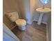 Powder room with a pedestal sink and elongated toilet with vinyl flooring at 209 Killarney Trl, Moncks Corner, SC 29461