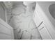 Bathroom with marble tile floor, white vanity, toilet, and door at 209 Killarney Trl, Moncks Corner, SC 29461