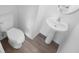 Clean bathroom features a white toilet and a pedestal sink, all well-lit at 209 Killarney Trl, Moncks Corner, SC 29461