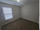 Standard bedroom with carpeting, neutral walls, and a single window at 209 Killarney Trl, Moncks Corner, SC 29461