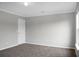 Bedroom with neutral walls, carpet, base molding, and a white door at 209 Killarney Trl, Moncks Corner, SC 29461