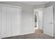 Bedroom with carpet, neutral walls, white base molding, and a set of closet doors at 209 Killarney Trl, Moncks Corner, SC 29461