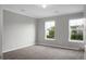 Bedroom with neutral walls, two windows, carpet, and a door at 209 Killarney Trl, Moncks Corner, SC 29461