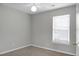 Cozy bedroom features neutral carpet, light gray walls, a ceiling fan and a window providing natural light at 209 Killarney Trl, Moncks Corner, SC 29461