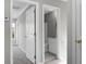 Hallway with neutral walls, carpet, and white doors leading to rooms including a bathroom at 209 Killarney Trl, Moncks Corner, SC 29461