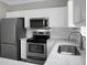 Elegant kitchen featuring stainless steel appliances and light stone countertops at 209 Killarney Trl, Moncks Corner, SC 29461