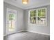 Bright room with a rear door and a window overlooking the yard, finished with gray walls at 209 Killarney Trl, Moncks Corner, SC 29461