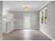 Inviting living room with light gray walls, modern light fixture, and an adjacent kitchen bar at 209 Killarney Trl, Moncks Corner, SC 29461