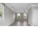 Spacious living room with gray walls, modern flooring, and multiple large windows at 209 Killarney Trl, Moncks Corner, SC 29461
